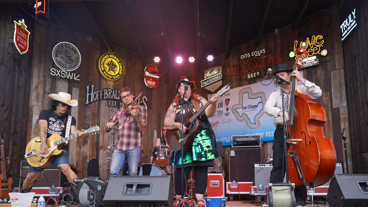 Secret Emchy Society standing on stage playing